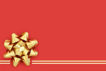 Gold ribbon gift bow for birthday anniversary present, greeting card, gift tag, label. Decorative contrast art abstract design. On red background, copy space.