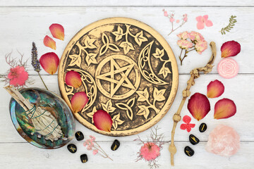 Witchcraft equipment and ingredients for healing and cleansing. Ritual objects, sage smudge stick, runes, rose petals, wooden wand, white magic symbols.
