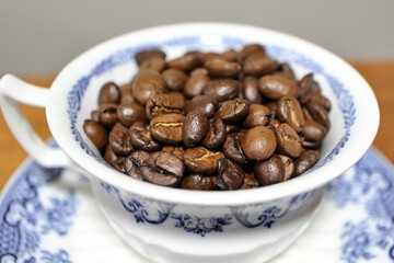 Roasted coffee beans in a coffee cup