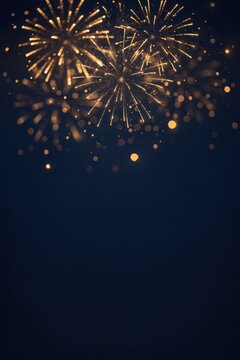 Blue and gold Abstract background and bokeh on New Year's Eve. Vertical Colorful fireworks lighting up the night sky in a festive display.