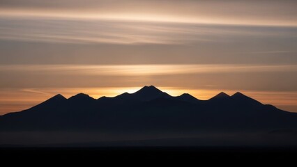 Golden hour glow over a dark mountain range