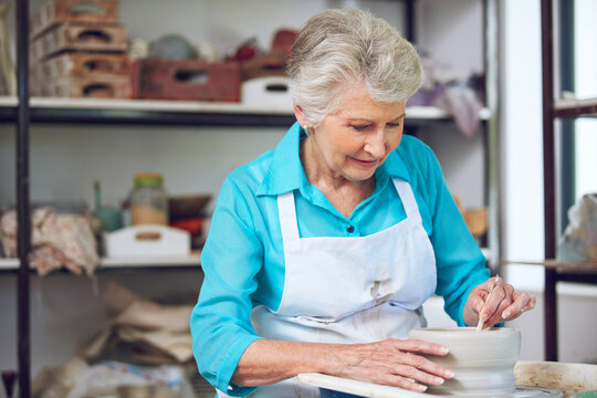 Pottery, clay and old woman with tools in studio for shape, handcraft and creative design. Wheel, ceramic art and happy senior person in workshop for hobby, mold and potter sculpting in retirement
