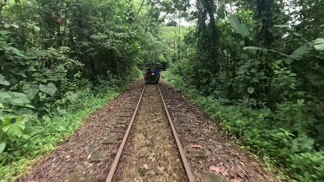 Riding a "motobrujita" little witches in Valle del Cauca, Colombia. Ingenious, community-run wooden cart uses a motorcycle engine on an abandoned train track in a pristine nature reserve