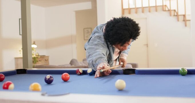 Entering room man picking cue stick blue-felt pool table aligning shot and striking billiard balls