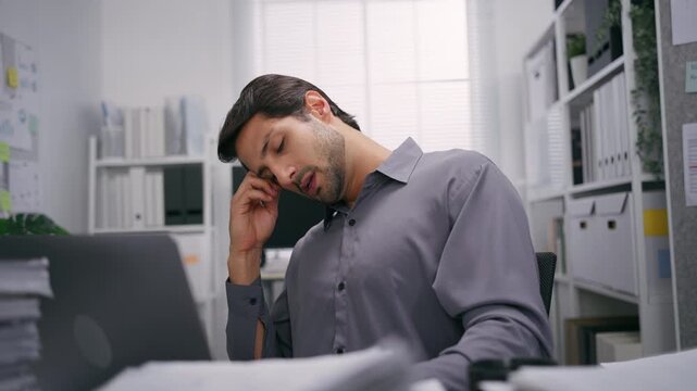 Overworked Exhausted  Office latin tired Man Working Late  with Stressful Paperwork and Deadline Pressure