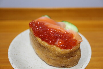 Salmon and ikura (salmon roe) inarizushi purchased at a supermarket in Tokyo, Japan