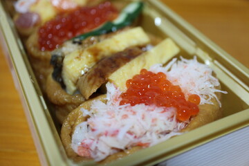 Snow crab and ikura (salmon roe) inarizushi purchased at a supermarket in Tokyo, Japan
