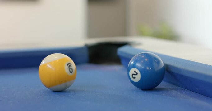 Red 3-ball rolling from left and colliding with yellow and blue balls nudging toward corner pocket