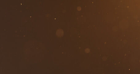 dust particles floating in air with warm light