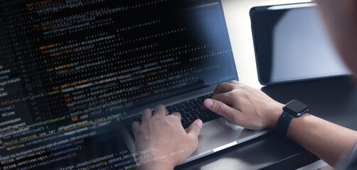 Software devloper coding javascript, using laptop computer, representing software development for...