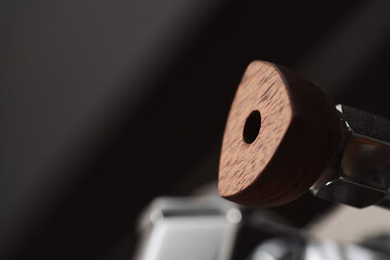 Closeup detail shot of walnut wood handles on coffee machine
