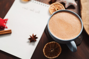 Hot chocolate in a blue cup with natural christmas decorations