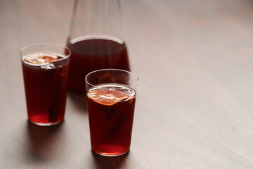 Mulled wine in tumbler glasses on walnut table with copy space