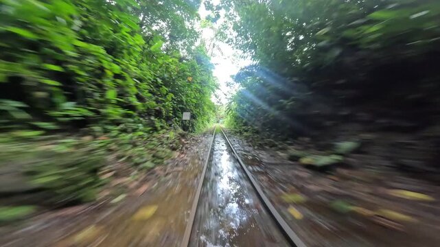 First-person view from a "motobrujita," "little witches" a unique motorcycle-powered rail cart, entering a dark, wet tunnel along the disused railway in San Cipriano, Colombia