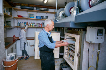Ceramic, process and old man in workshop with oven, skills or creative hobby in retirement. Preparation, art and people in studio with kiln, production or sculpture craft in senior activity.