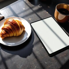 Stock photo of croissant and coffee with tablet for breakfast morning food photography concept 100 characters