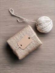Wrapped Gift with Tag and Twine on Wooden Surface