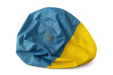 Deflated blue and yellow beach ball lying crumpled, representing the end of summer activities and forgotten fun