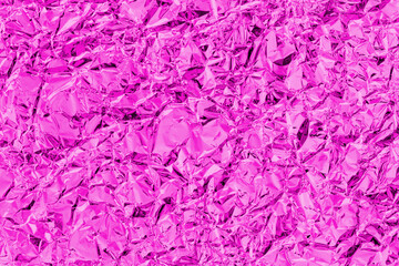 Shiny metal pink foil leaf crumpled texture background.