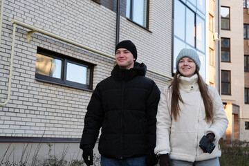 Young couple walking smiling enjoying urban lifestyle