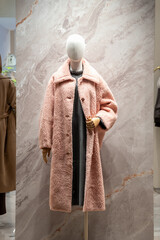 Mannequin Displaying Pink Wool Coat in Fashion Store