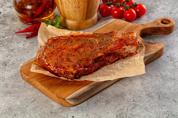Raw marinated pork loin steak