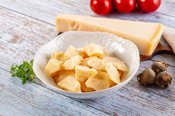 Parmesan cheese pieces in the bowl