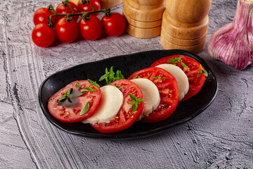 Italian caprese salad with mozzarella, tomato and basil