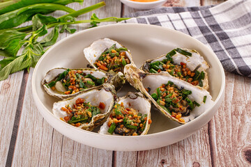 Gournet grilled oysters with onion and peanut