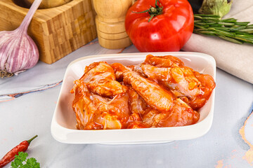 Raw marinated uncooked chicken wings