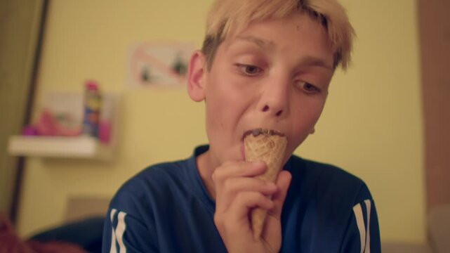 white boy licking ice cream cone in bedroom, soft shelves in background, slow satisfied licks, playful quiet snack,