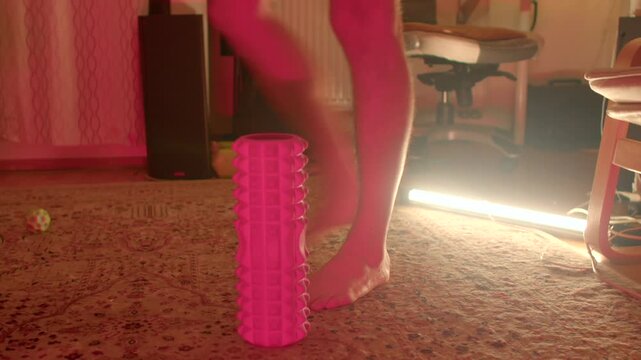 bare feet stepping onto upright foam roller carpet warm studio light activation drill for foot strength balance
