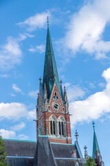 Obraz premium A tower of Majestic church Herz Jesu Kirche against blue sky in Graz, Styria, Austria.