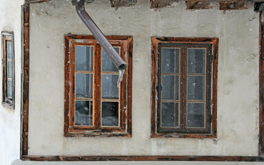 Old windows and frozen waterspout
