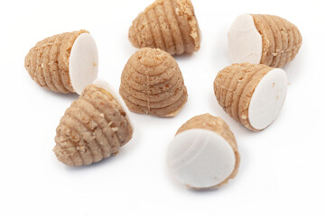 Traditional Silesian bee-hive shaped cookies made from ground nuts on a clean white background, regional Polish dessert prepared for holidays and local culinary culture