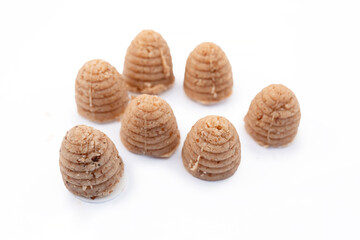 Traditional Silesian bee-hive shaped cookies made from ground nuts on a clean white background, regional Polish dessert prepared for holidays and local culinary culture