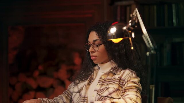Young Black woman opening laptop and starting work on creative project