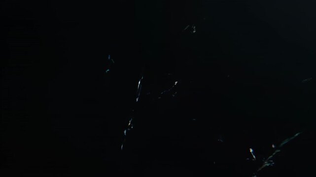 Ominous cinematic slow motion glitch featuring sharp diagonal static lines briefly flashing across a deep black empty screen digital, system error, dark background