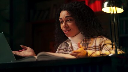 Friendly Black female teacher explaining material during online video lesson