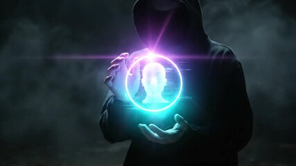 Anonymous hacker in dark hoodie holding a glowing neon holographic human profile icon in smoky atmosphere representing cybercrime or digital identity theft