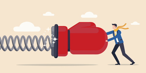 Businessman pushing a giant boxing glove attached to a spring overcoming challenges