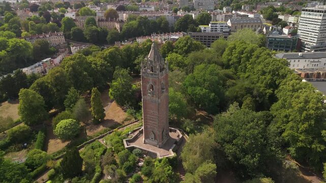 Bristol UK: 28th July 2025: Breathtaking drone view of Cabot Tower surrounded by lush greenery of Brandon Hill park. With University of Law in background