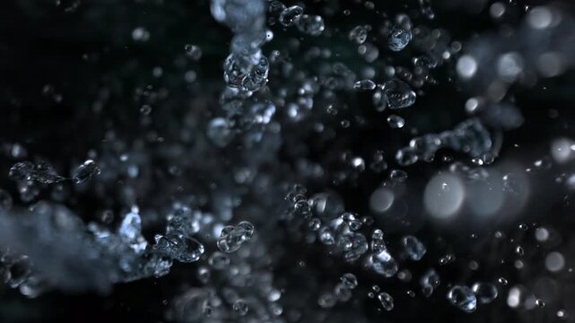 Super Slow Motion Shot of Falling Water Drops on Black Background at 1000fps.