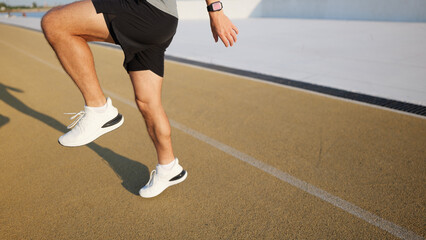 Running on a track in training session with warm-up exercise