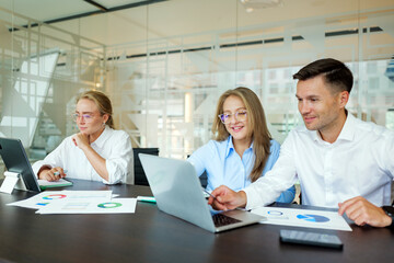 Workers discuss plans in modern office setting