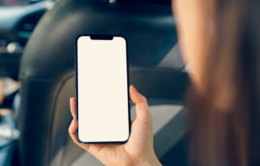 Woman sitting in a private car and hand holding smartphone mockup of blank screen, Take your screen to put on advertising
