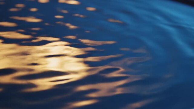 Slow motion cinematic view of golden caustic light rippling across a deep azure surface leaving subtle, fluid afterimage trails of distortion light, pool, sea