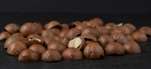 Macadamia nuts pattern. Natural raw peeled macadamia seeds and shells