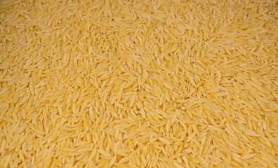 Raw orzo pasta, risoni or kritharaki pile