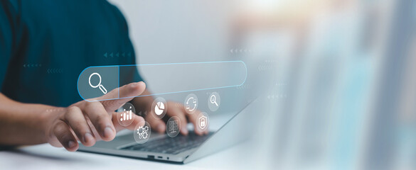 A person interacting with a digital search bar on a laptop represents online searching, data analysis, SEO optimization, and modern technology for effective information discovery business insights.